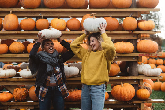Two best friends in their twenties at a pumpkin patch