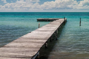 Fotobehang Houten pier op het eiland Caye Caulker, Belize © Matyas Rehak