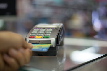 Paying by credit card with   paying with contactless credit card with a credit card reader machine.