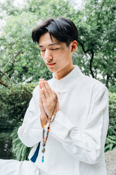 Asian man with zen buddha gesture