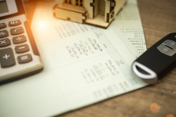 close up of car remote and account book in finance and banking