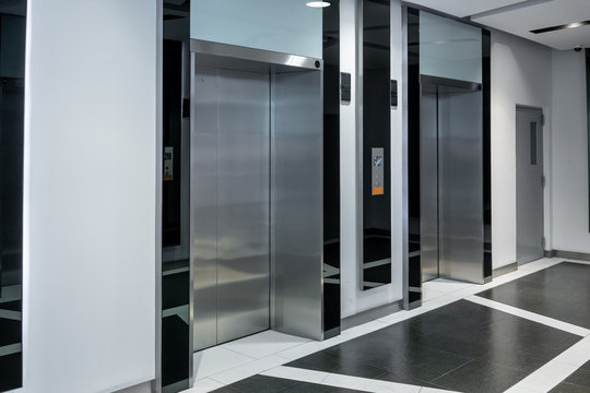 Modern steel elevator cabins in a business lobby or Hotel, interior, office,perspective wide angle.