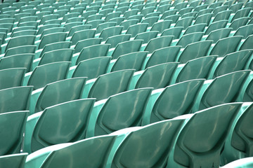 Close up of back of a green arena seats