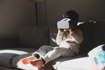 Little kid playing with virtual reality glasses