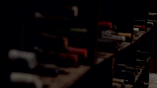 Old vintage wine bottles in dark wine cellar close up Australia