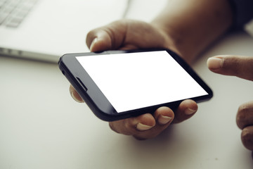 hands holding blank screen mobile in desk work.