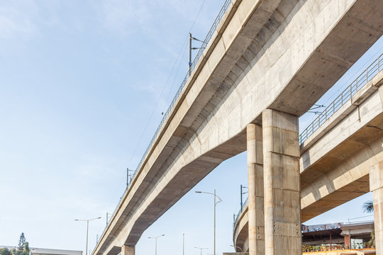 double berth metro train bridge construction and train seen moving. fastest mode of transport with cost effective. abstract of multiple pillars and metro station dome