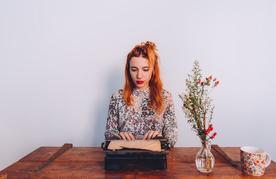 woman working on a vintage typewriter