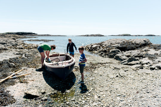 kids on rowboat at sea