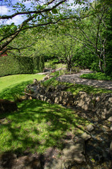 Small walking path in  summer green botanic garden. Berlin, Germany.