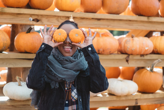 A young woman in her twenties at a pumpkin patch