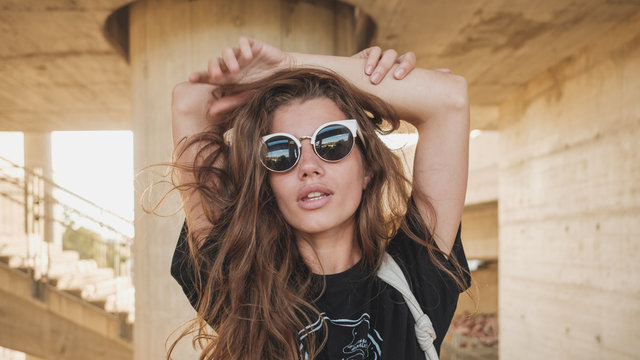 Portrait Of Young Hip Female Model Wearing Sunglasses