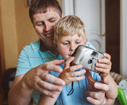 Father playing with baby boy indoors