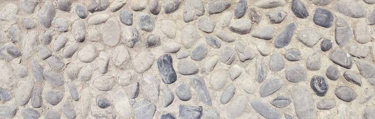 background and texture of granite stone wall surface. Close up of a natural stone carpet. Decorative stone coating. Slip resistant floor finish containing natural stone particles.