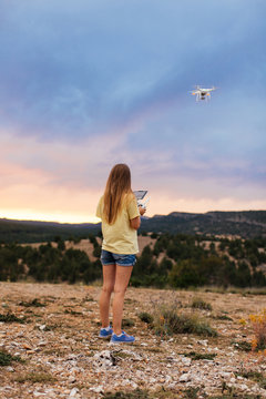 Woman flying drone at mountains