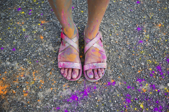Female feet dirty with colored powder
