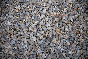 Close-up of gray stones of different sizes on the floor in the old town, background