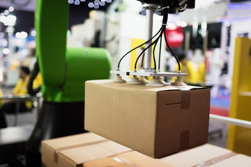 Automatic hand hold the cardboard box at factory in Thailand.