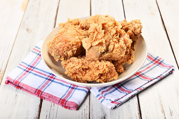Crispy fried chicken on wooden table