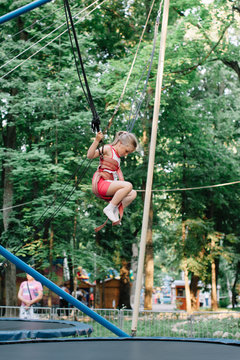 Little girl jumping on trampoline