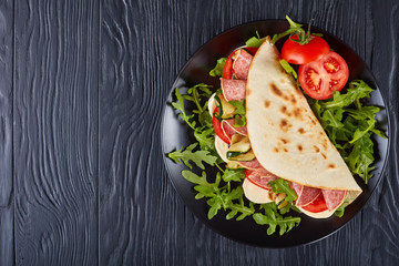 italian piadina with mozzarella, tomato, salami