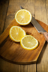 cut lemon on a cutting board with a knife