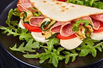 piadina with mozzarella, tomato, salami, zucchini