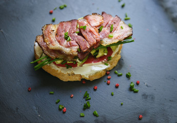Sandwich with bacon, avocado and onion.
