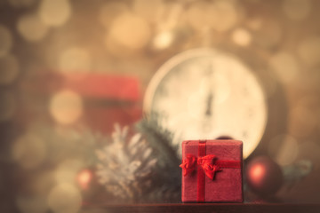 photo of gifts, alarm clock, lolipop and Christmas decorations on the wonderful brick wall background