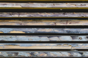 Old stacked weathered wooden boards