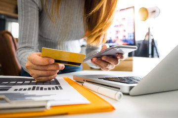 Business man hands using smartphone and holding credit card with digital layer effect diagram as Online shopping concept