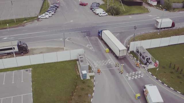 Aerial Shot of Truck with Attached Semi Trailer Leaving Warehouse complex