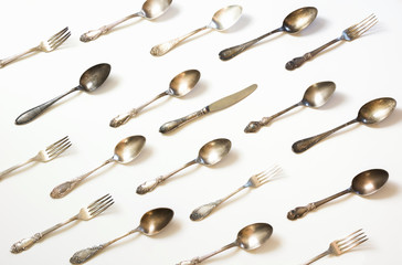 Spoons, forks, knives, silverware pattern on white background. Kitchen texture. Top view