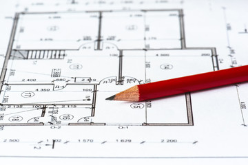 The architectural plan of the house is printed on a white sheet of paper and red pencil on it