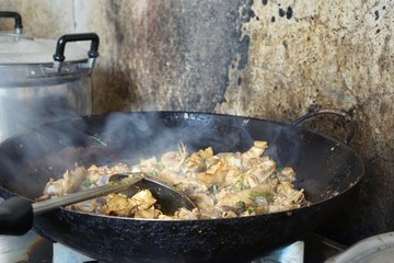 Cooking chicken, Stir fried chicken ginger and vegetables with smoke in pan on old wall, Steaming pan with chicken on stove, Asian food, stir fry