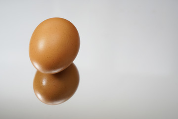 an egg on the surface of a mirror