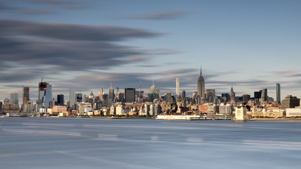 New york city skyline daytime sun clouds blue