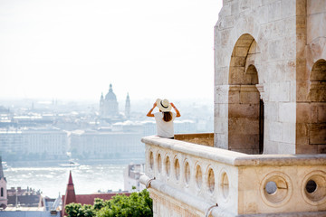 View on the wall of Fiserman's bastion with woman standing on the terrace enjoying great view on...