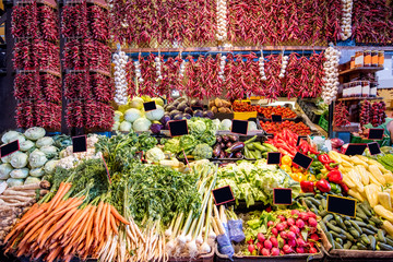 Counter filled with various vegetables and famous hungarian paprika in the great market hall in...