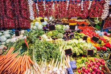 Counter filled with various vegetables and famous hungarian paprika in the great market hall in Budapest