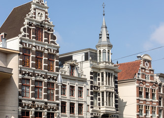 Fototapeta premium Typical gabled houses on Damrak street in Amsterdam, Holland, Netherlands