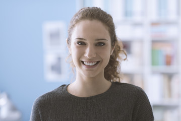 Smiling young woman posing at home