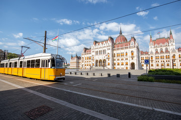 Fototapeta na wymiar Parliamen tbuilding with yellow tram on the central square in Budapest city, Hungary