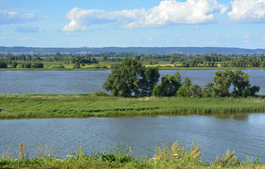 Landscape with river. Beautiful russian nature. Green meadows and forests on the banks in summer day.