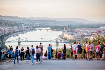 Papier Peint photo Budapest People enjoying great view on Budapest city with Danube river and bridge during the sunset in Hungary. People is out of focus