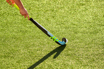 battle for control of ball during field hockey game