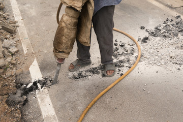Workers drill the road to the water pipe after not coordinating with the highway department.