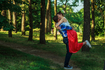 Attractive young couple hugging each other on pathway in forest