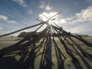 wooden teepee on the beach, New Zealand 