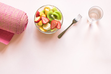 Pink yoga mat and Fruit Salad